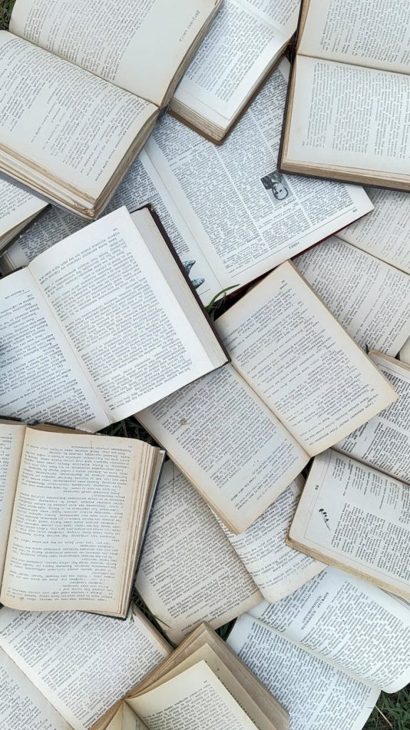 Collection of vintage open books scattered for study reference or research background.